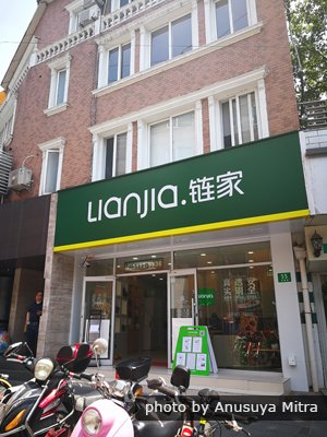 Successful real estate company Lianjia is branded in green and yellow.